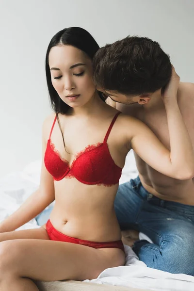 Young Shirtless Man Kissing Attractive Asian Girlfriend Red Lingerie — Stock Photo, Image