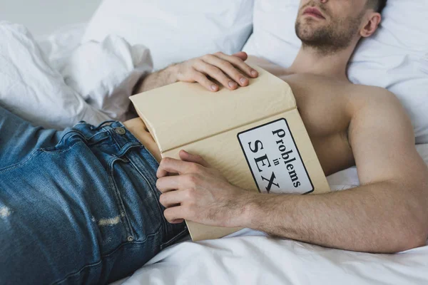 Częściowy Widok Mężczyzny Trzymał Problemy Książce Seksualnej Leżąc Białej Pościeli — Zdjęcie stockowe
