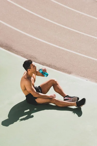 Mixed Race Sportsman Sitting Stadium Drinking Water — Stock Photo, Image