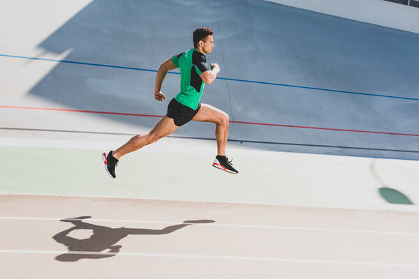 full length view of mixed race sportsman running at stadium