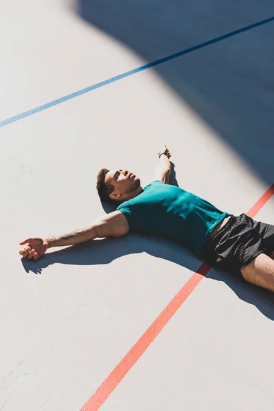 Mixed Race Sportsman Laying Running Track Spread Arms — Stock Photo, Image