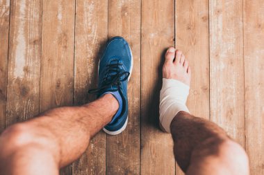 elastik bandaj bir ayak ile bir spor ayakkabı oturan yaralı sporcunun kırpılmış atış