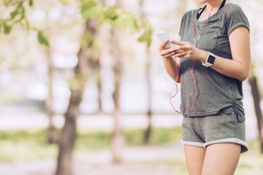 akıllı telefon ve kulaklık müzik dinleme kullanarak fitness izci sporcu nun kırpılmış atış