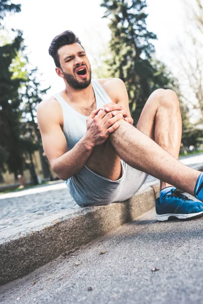 Injured Sportsman Suffering Hurt Screaming While Sitting Border Touching Leg — Stock Photo, Image