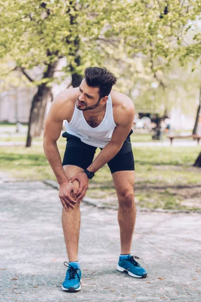 Handsome Sportsman Suffering Hurt While Touching Injured Knee — Stock Photo, Image