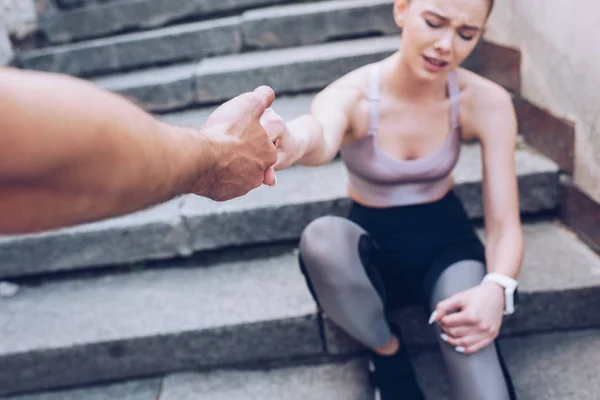 Cropped Man Giving Hand Injured Sportswoman Suffering Pain While Sitting — Stock Photo, Image