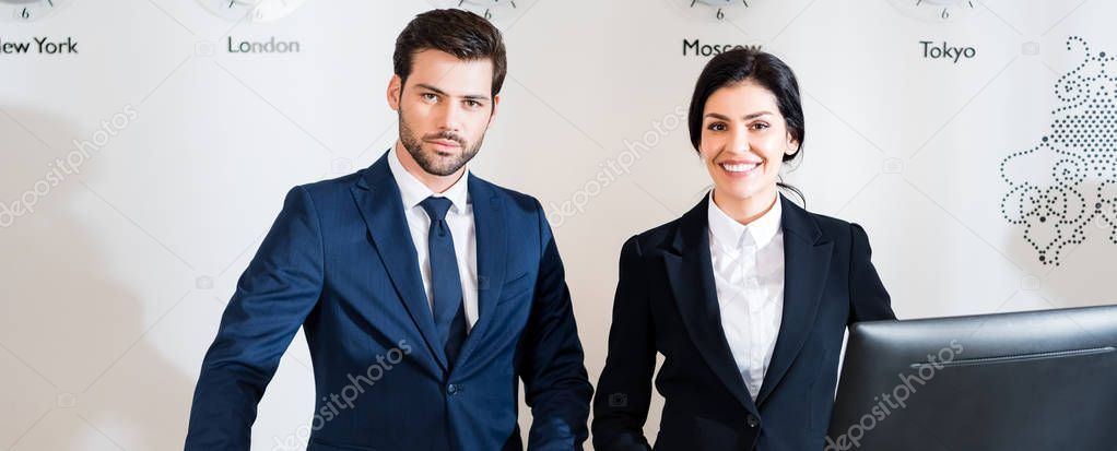 panoramic shot of cheerful woman near serious man in suit 