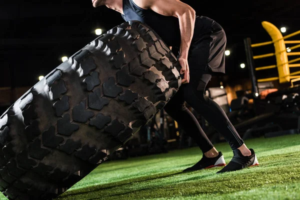 Cropped View Strong Man Working Out Huge Car Tire Green — Stock Photo, Image