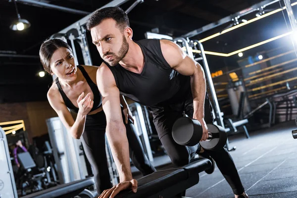 Attractive Trainer Talking Bearded Man Working Out Dumbbell — Stock Photo, Image