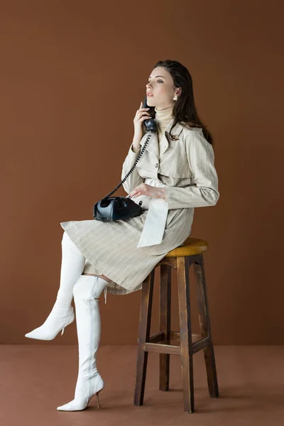 Attractive Model Talking Telephone Looking Away Sitting Isolated Brown — Stock Photo, Image