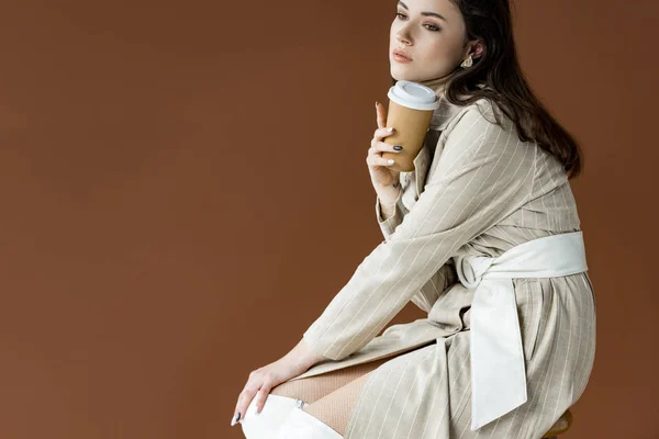 Beautiful Model Looking Away Sitting Isolated Brown Holding Paper Cup — Stock Photo, Image