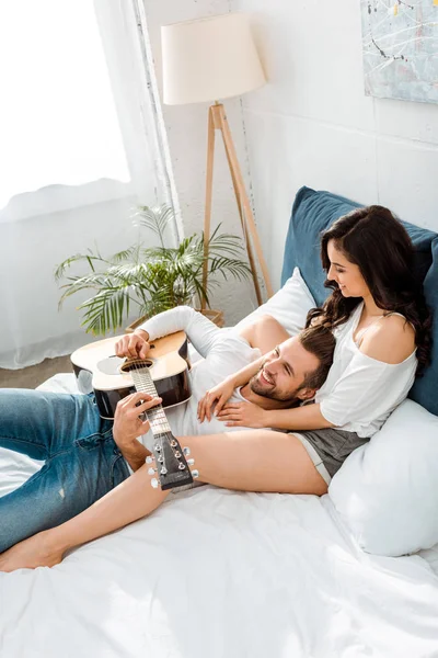Handsome Happy Man Lying Acoustic Guitar Woman Bed — Stock Photo, Image