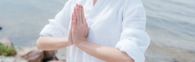 panoramic shot of young woman with praying hands  clipart
