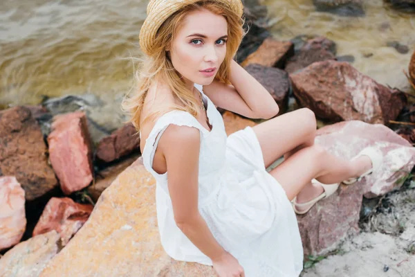 Overhead View Blonde Girl Touching Straw Hat While Sitting Stones — Stock Photo, Image