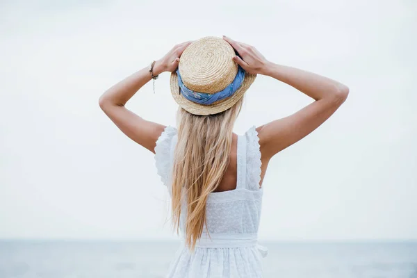 Back View Young Blonde Woman Standing Touching Straw Hat — Stock Photo, Image