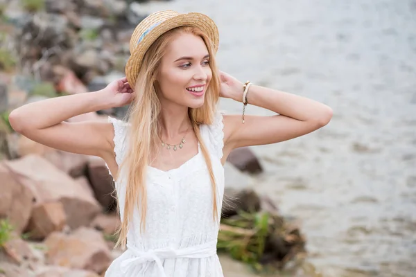 Pretty Blonde Girl Standing Smiling While Touching Straw Hat — Stock Photo, Image