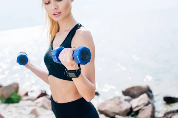 Cropped View Blonde Young Woman Exercising Blue Dumbbells Sea — Stock Photo, Image