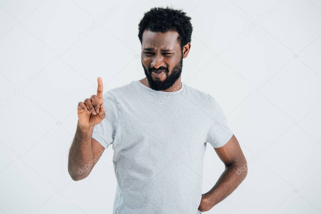 beard african american man in grey t-shirt pointing up isolated on grey