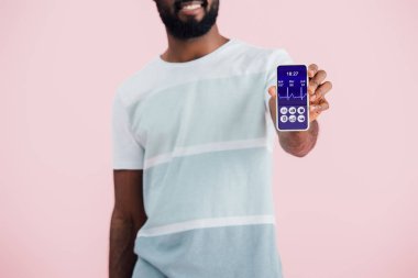 pembe izole sağlık uygulaması ile akıllı telefon gösteren Afrikalı-Amerikalı adam kırpılmış görünümü 