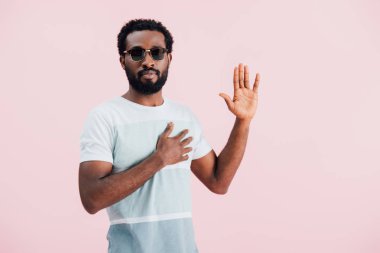 young african american of man in sunglasses gesturing isolated on pink