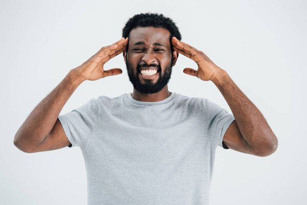 ill african american man having headache isolated on grey