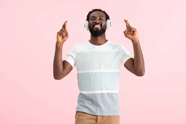 目を閉じて指を組んで音楽を聴き ピンクで孤立した幸せなアフリカ系アメリカ人男性 — ストック写真