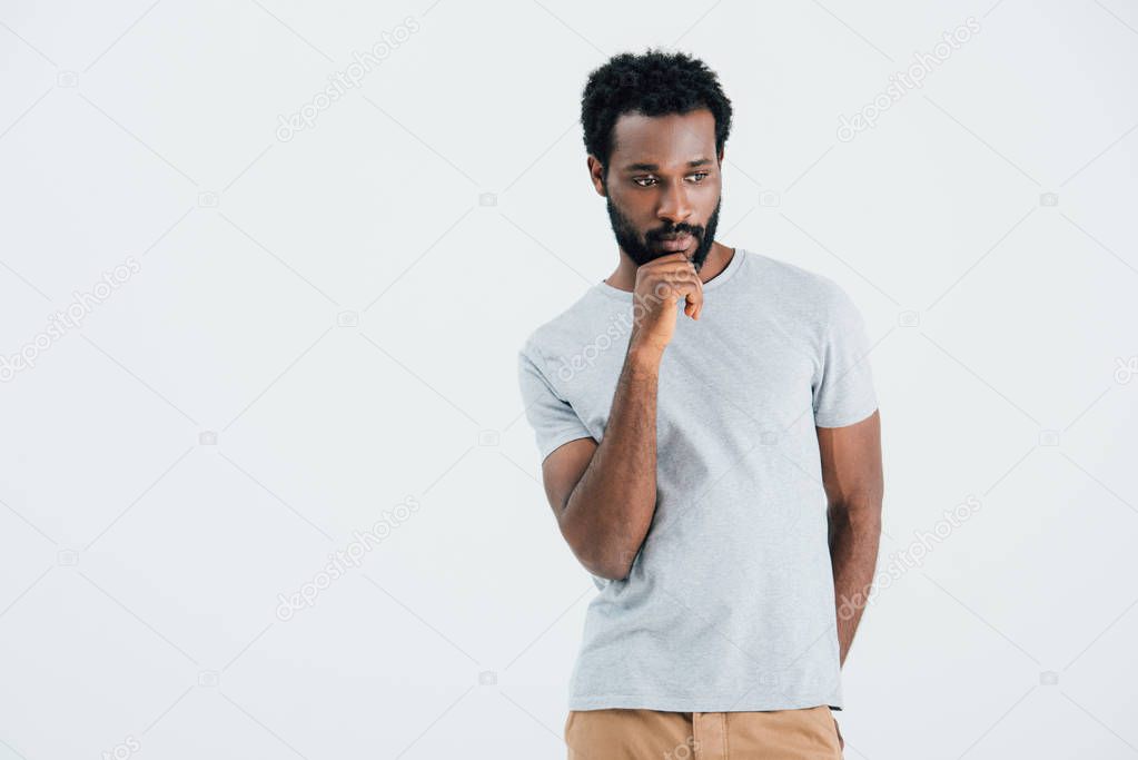 thoughtful african american man in grey t-shirt, isolated on grey