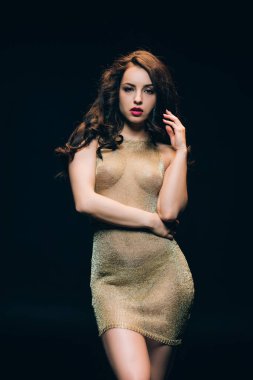 sexy elegant young woman in golden transparent dress isolated on black clipart