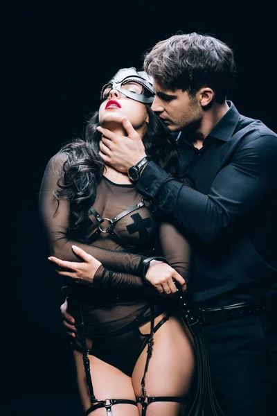 Young Man Touching Sexy Brunette Woman Bdsm Costume Isolated Black — ストック写真