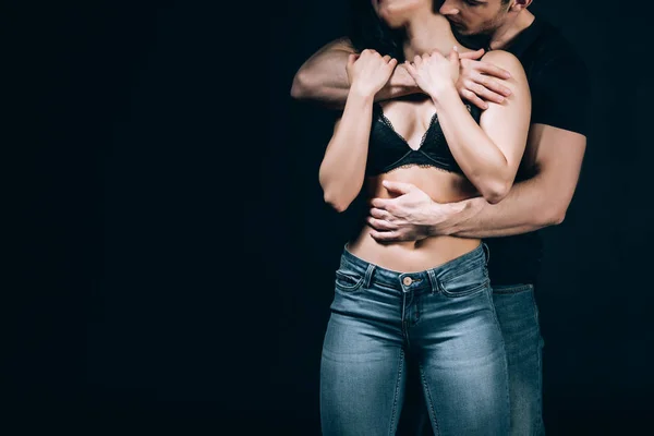 黒で孤立したセクシーなガールフレンドを抱きしめ キスする男のトリミングされたビュー — ストック写真