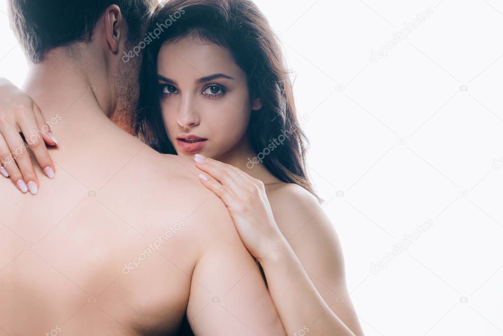 brunette young woman embracing naked boyfriend isolated on white