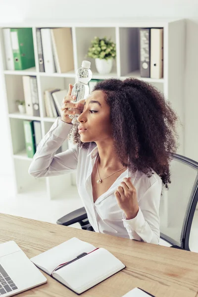 Exhausted African American Businesswoman Suffering Heat Office Holding Plastic Bottle — Stock Photo, Image