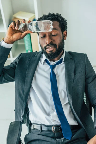 African American Businessman Holding Plastic Bottle Water Head While Suffering — Stock Photo, Image