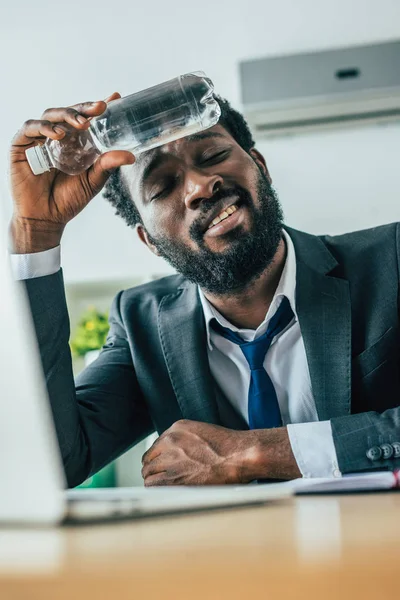 Selective Focus Exhausted African American Businessman Holding Bottle Water Head — Stock Photo, Image