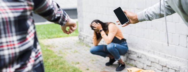 cropped view of african american boy and teen pointing with finger and shooting scared teenager