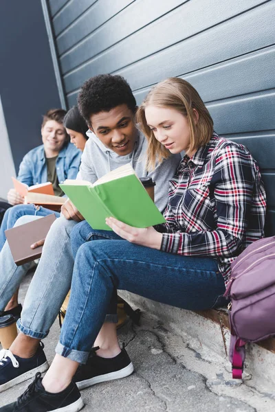 African American Caucasian Teenagers Sitting Talking Reading Book — Stock Photo, Image