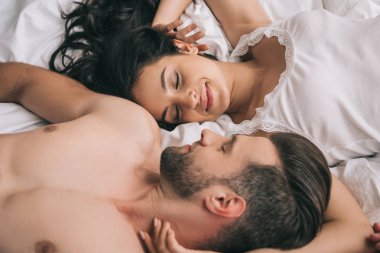 attractive woman with closed eyes and handsome man sleeping  clipart
