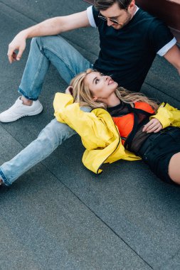 çekici kadın ve gözlük çatıda oturan ve çatıda konuşurken yakışıklı adam 