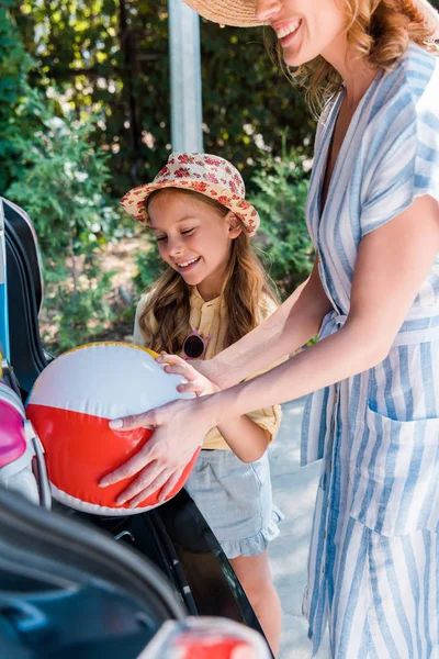 Cropped View Mother Putting Beach Ball Car Daughter — Stock Photo, Image