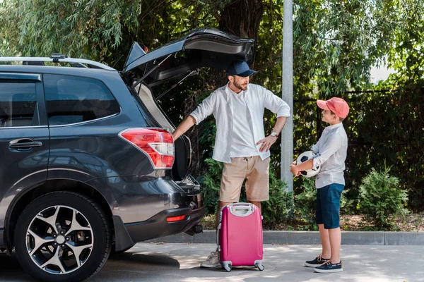 Gelukkige Vader Cap Staande Met Hand Hip Buurt Van Zoon — Stockfoto