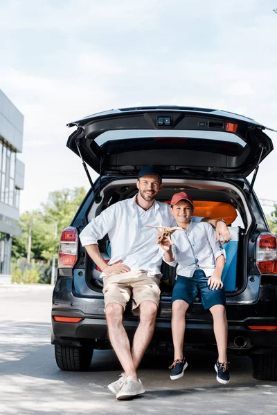 Alegre Padre Sentado Cerca Hijo Con Biplano Madera Cerca Coche — Foto de Stock