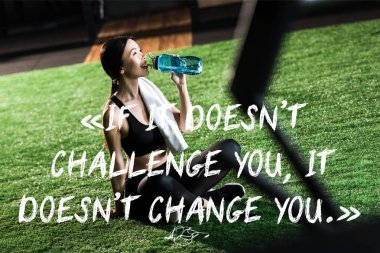 selective focus of happy woman sitting on grass and drinking water with if it doesnt challenge you, it doesnt change you quote clipart