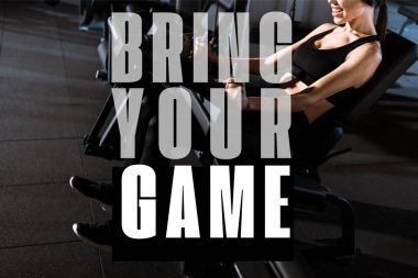 cropped view of athletic woman exercising on training apparatus in gym with bring your game illustration clipart