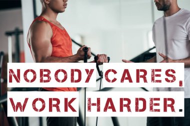 partial view of trainer and african american sportsman near illustration with nobody cares, work harder inscription clipart