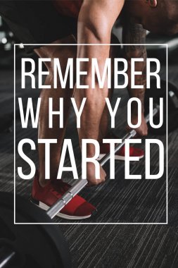 cropped view of african american sportsman lifting barbell near illustration with remember when you started inscription clipart