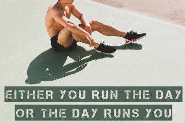 cropped view of sportsman in black sneakers sitting at stadium with either you run the day or the day runs you lettering clipart