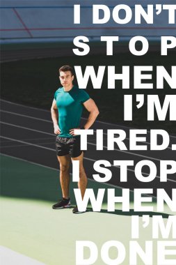 mixed race sportsman standing with hands on hips at stadium and looking at camera with i dont stop when i am tired, i stop when i am done lettering clipart
