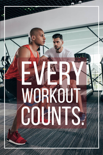 attentive trainer supporting african american sportsman near illustration with every workout counts inscription