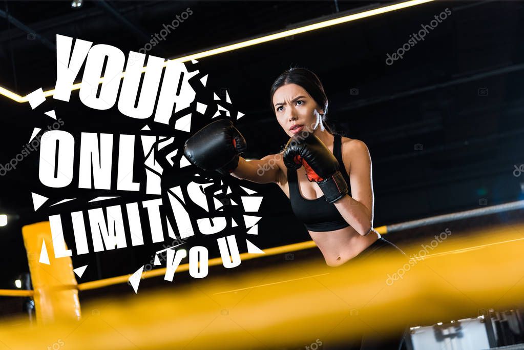 selective focus of serious woman boxing while standing in boxing gloves in gym with your only limit is you illustration 