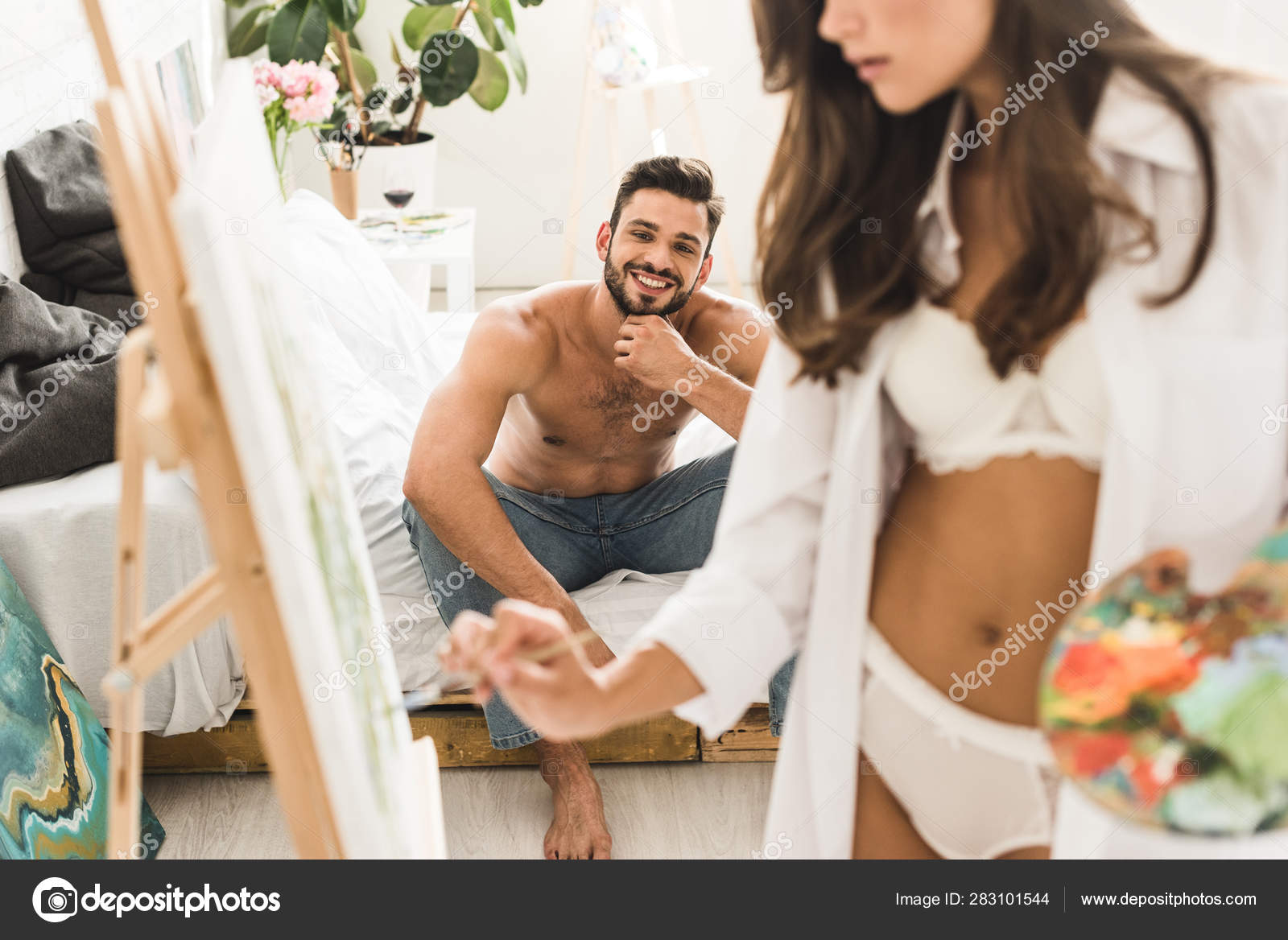 cropped view of sexy girl in white underwear drawing guy while man sitting  in bed with wine Stock Photo by LightFieldStudios